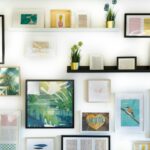 Wall decor featuring colorful framed prints and potted plants.