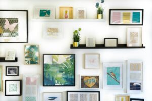 Wall decor featuring colorful framed prints and potted plants.